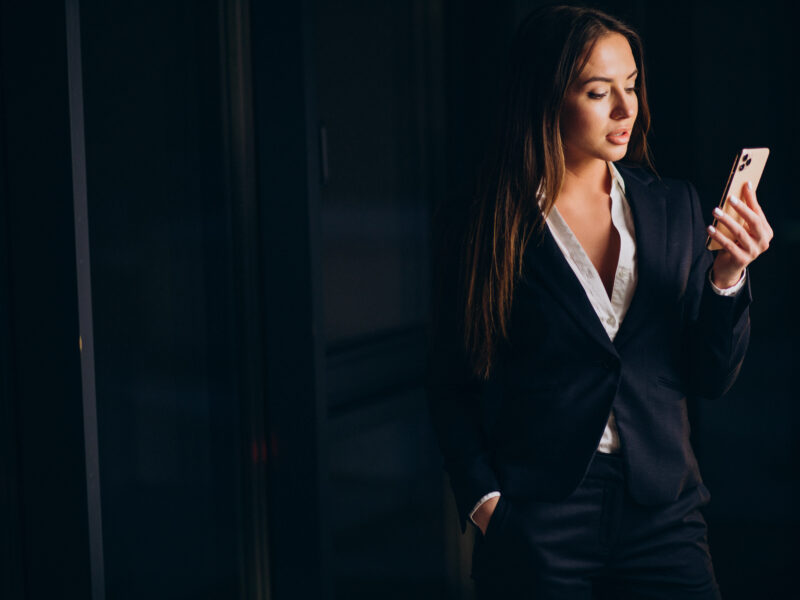 business woman talking phone staying late night office