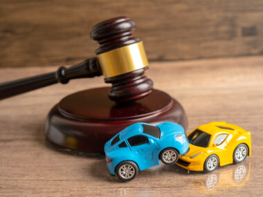 hammer gavel judge with car vehicle accident insurance coverage claim lawsuit court case