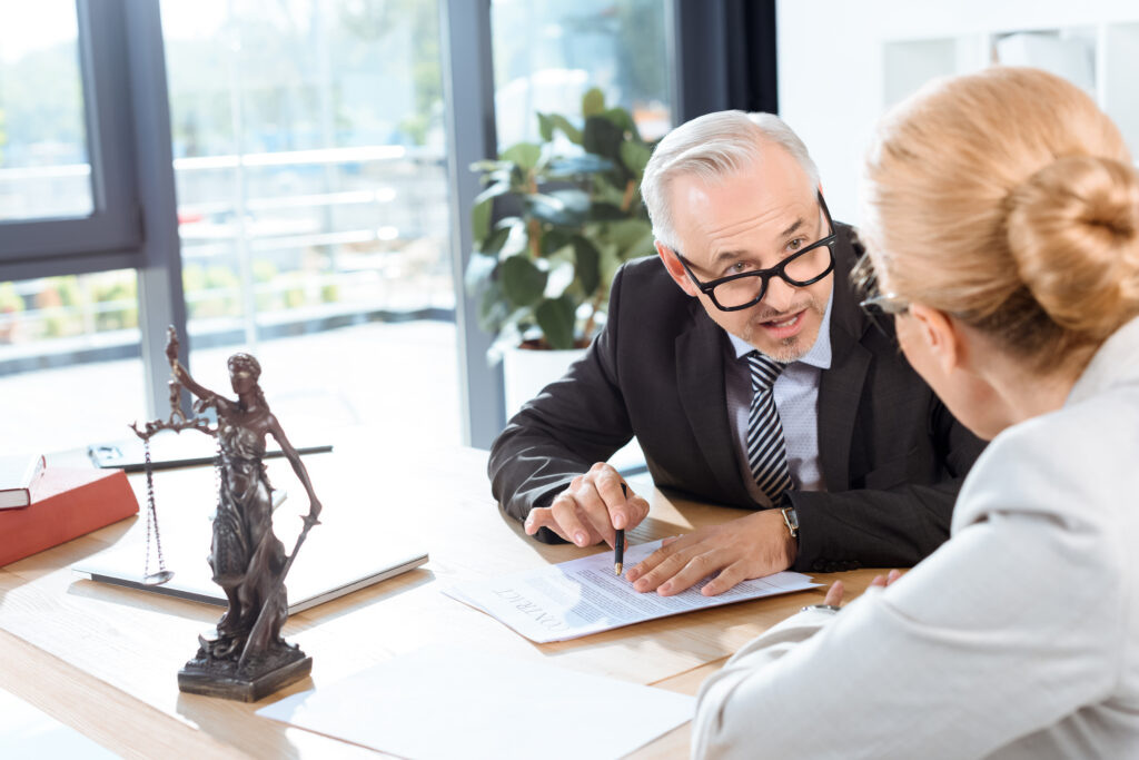 mature serious lawyers discussing business documents office