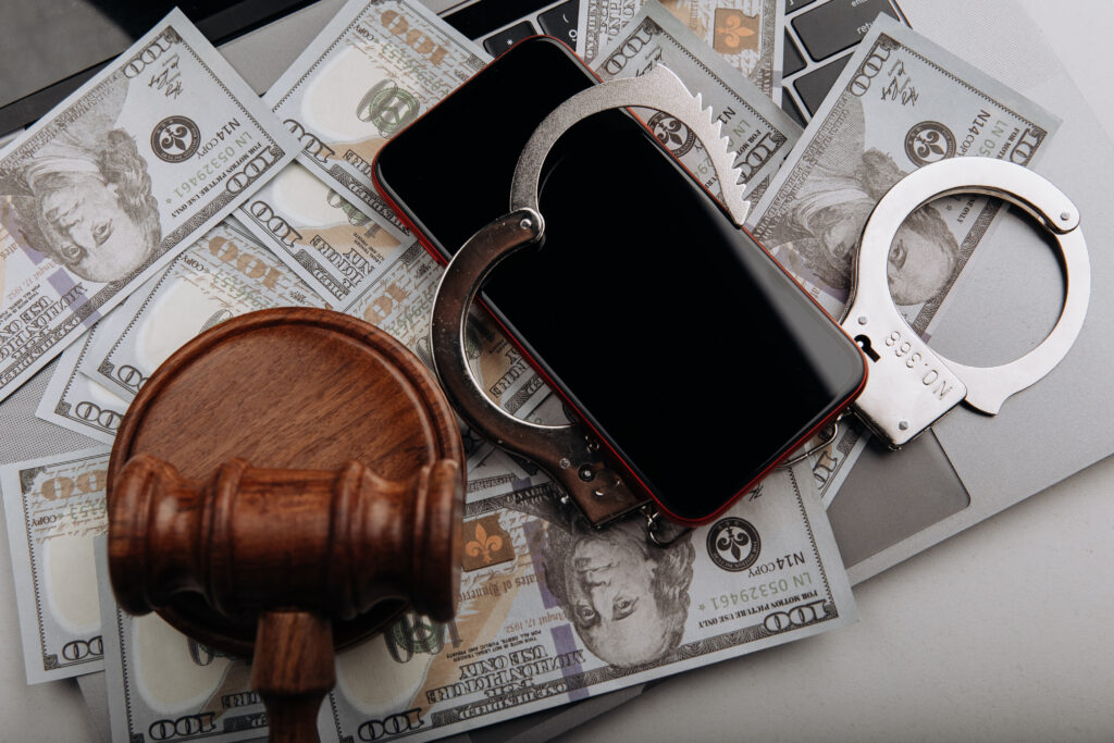 smartphone with handcuff judge gavel cash cyber crime law concept.Robbery Lawyer