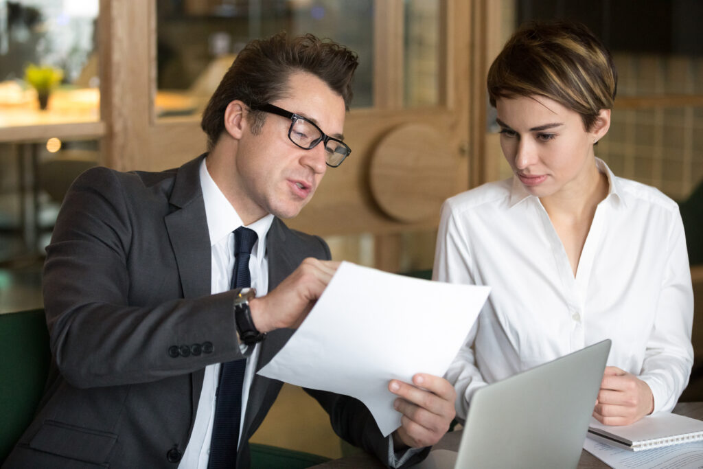 businessman consulting with female colleague contract conditions